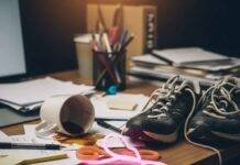 Fitness Tips for Busy People: 10 Ways to Stay Active in a Hectic Schedule A blurry photo of a messy desk with a spilled coffee mug, tangled running shoes, and a glowing neon-pink resistance band.
