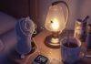 Sleep Disorders and Their Impact on Mental Health A blurry, high-resolution shot of a cluttered nightstand with a flickering sleep tracker, tangled sleep mask, chipped mug with tea stains, and a firefly near a lamp, in muted purples, grays, and gold.