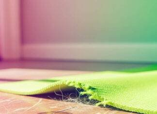 op Sleep Disorder Resources: Everything You Need to Sleep Soundly A close-up of a torn green mat on a wooden floor, with pet hair and scratches visible.