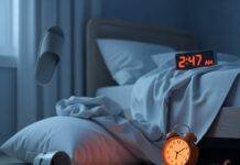 Sleep Disorder Awareness: Spot Symptoms and Get Help Fast A messy bedroom at 2:47 AM with a glowing orange alarm clock, crumpled sheets, a spilled coffee mug, and an upside-down slipper.