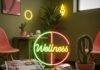 Wellness Clinics Near Me: Your Guide to Choosing the Best Option A blurry photo of a quirky wellness clinic waiting room with a neon sign, magazines, tea bags, and a cactus.