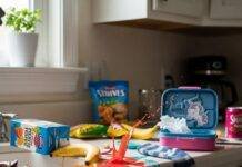 Best Nutrition for Kids: A Parent’s Guide to Healthy Eating A messy kitchen counter with spilled juice, a banana, a lunchbox, and a sock.