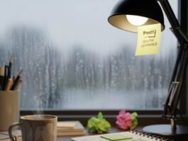 Mental Health Wellness: The Ultimate Guide to Improving Your Emotional Wellbeing A cluttered desk with a coffee mug, notebook, and a rainy window.