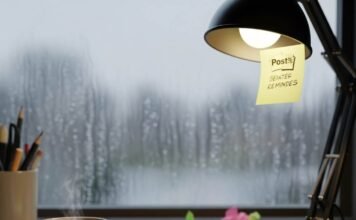 Mental Health Wellness: The Ultimate Guide to Improving Your Emotional Wellbeing A cluttered desk with a coffee mug, notebook, and a rainy window.